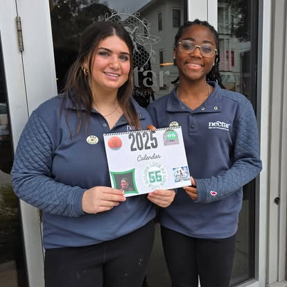Nectar team members hold a DJ's Day of Giving supporter plaque
