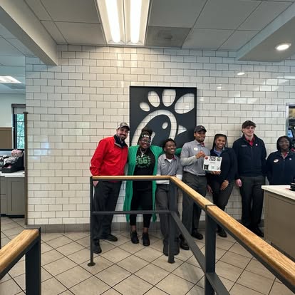 A Chick-fil-A team gathers for DJ's Day of Giving